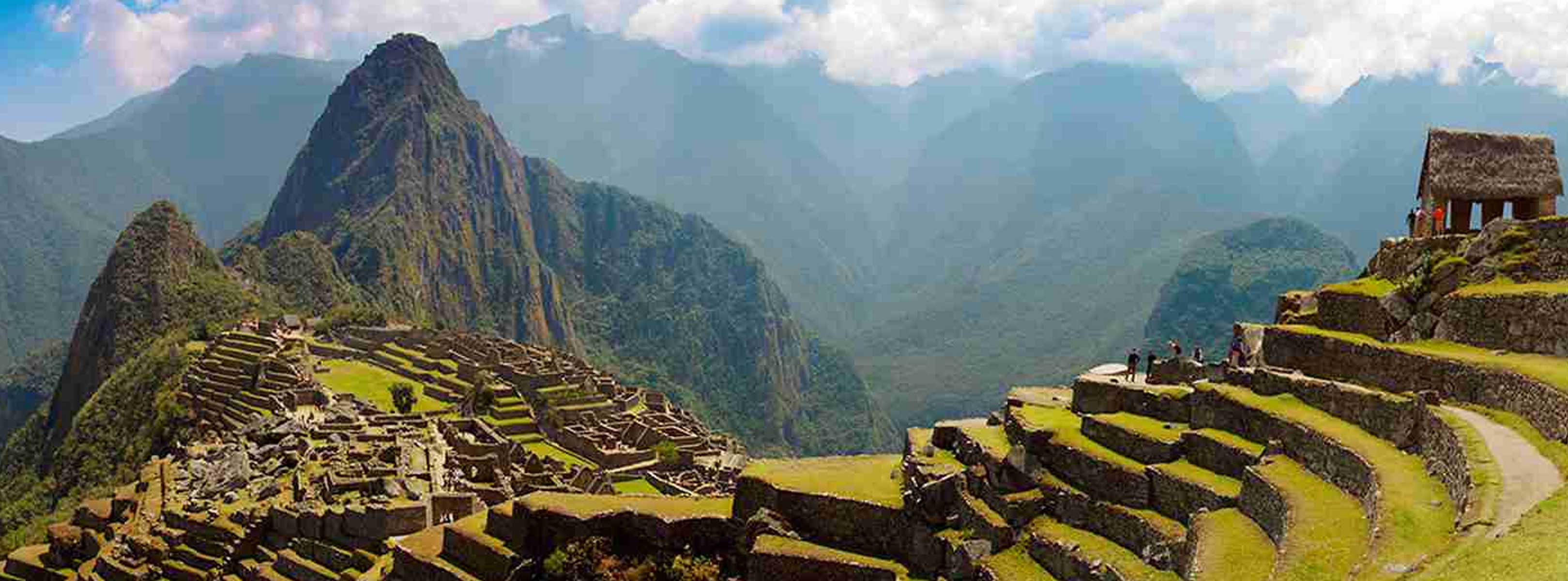 Image of ancient stone ruins nestled in green mountains